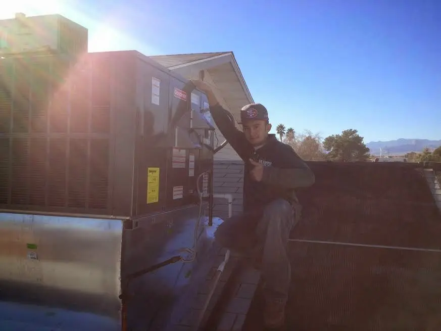 HVAC technician performing Air Duct Cleaning on a rooftop unit in West Puente Valley